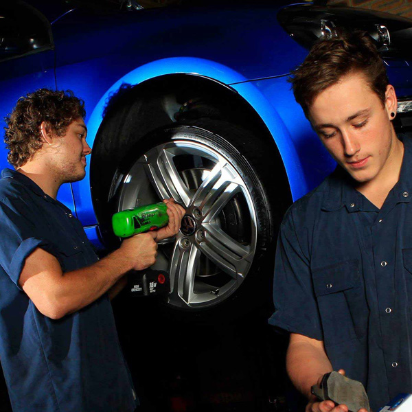 two-men-working-on-a-wheel